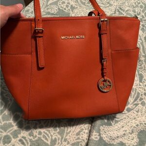 Barley used Michael Kors Orange shoulder bag.